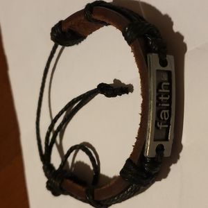 Black bracelet that says Faith on it